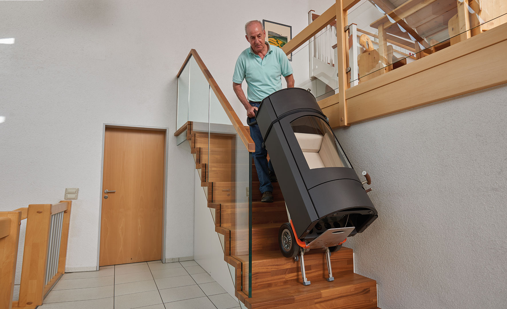 Der neue Ofen wird über die Treppen direkt in den Oberen Stock gebracht